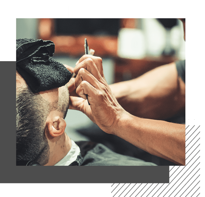 A man getting his hair cut by another person.